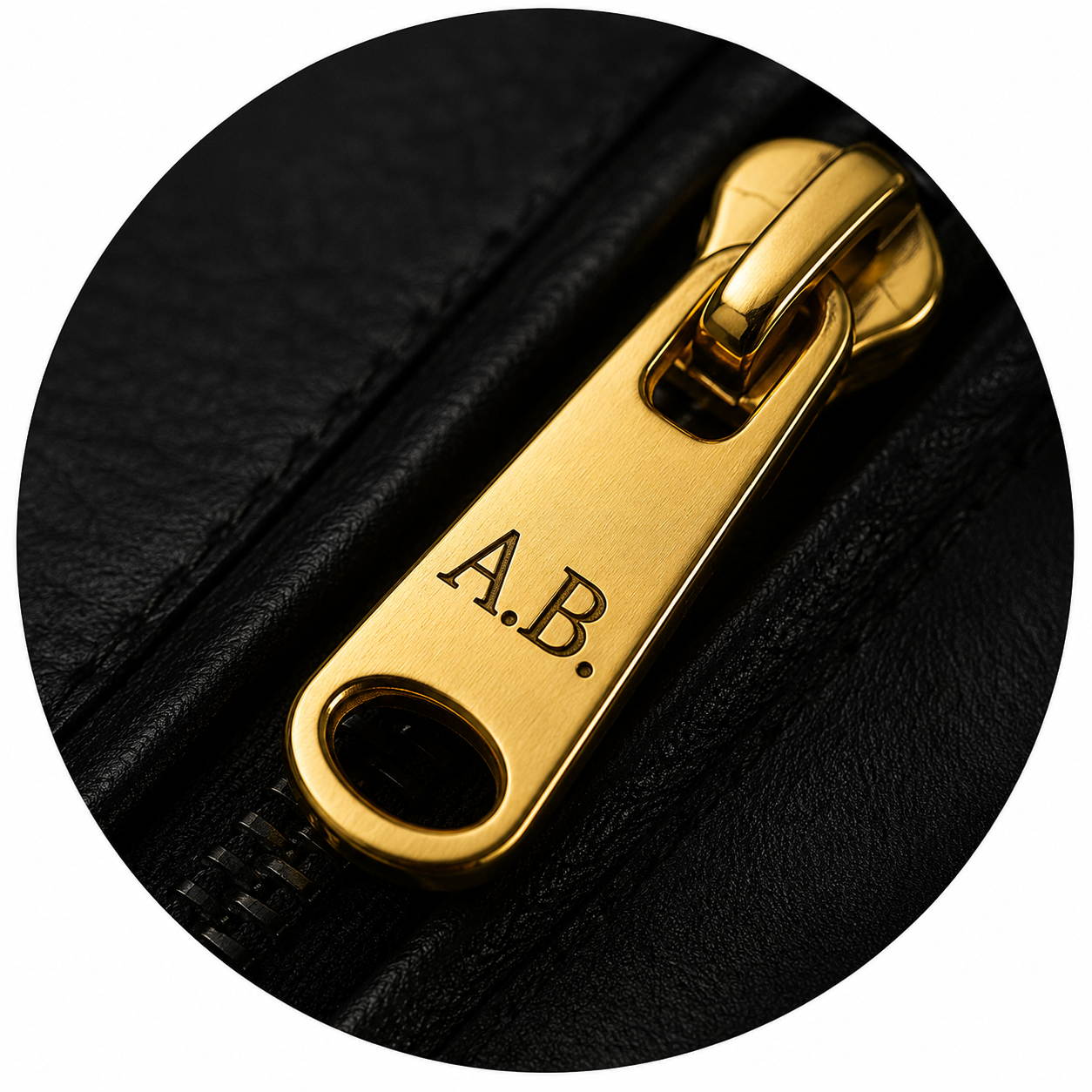 Gold zipper pull engraved with A.B.